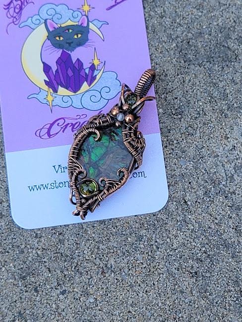 Ammolite w/ Peridot in Antiqued Copper w/ Peekaboo Crescent Moon in the Back Wrapped by Hand