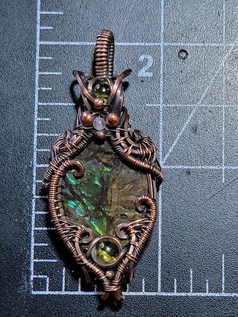 Ammolite w/ Peridot in Antiqued Copper w/ Peekaboo Crescent Moon in the Back Wrapped by Hand
